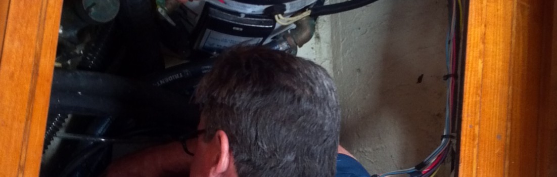 Chuck (top) and Dave (bottom) working on the engine aboard Astraea