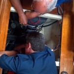 Chuck (top) and Dave (bottom) working on the engine aboard Astraea