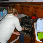 Natalie putting her first batch of cookies in the oven Natalie putting her first batch of cookies in the oven