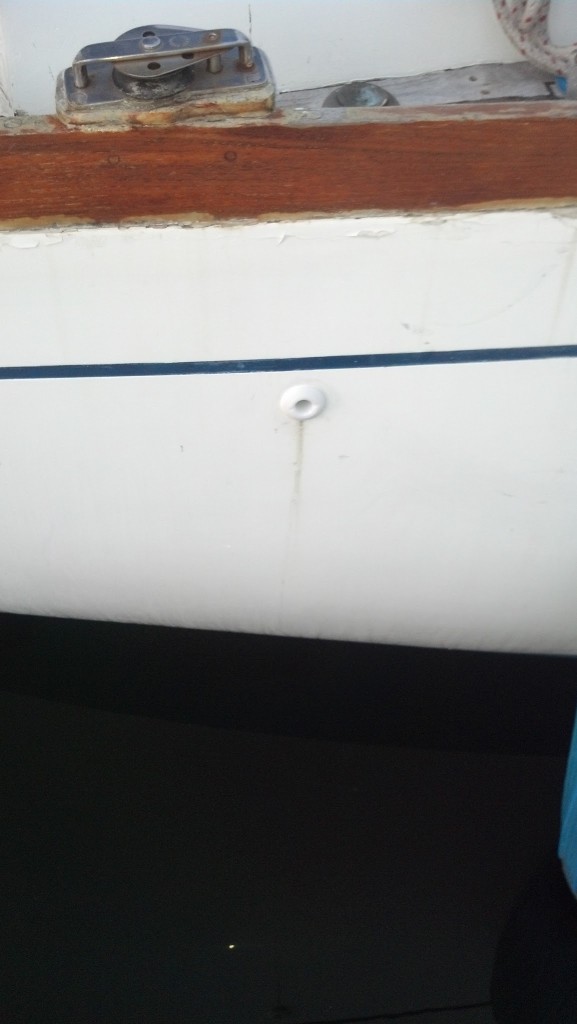 Then I applied some 3M 5200 around the inside of the lip and slid the through hull in to place. Next I cleaned up the excess 5200. I also need to scrub off the stain on the side of the boat from the old through hull corroding. I chose 3M 5200 sealant because the fitting is above the waterline but could be submerged on a starboard tack.